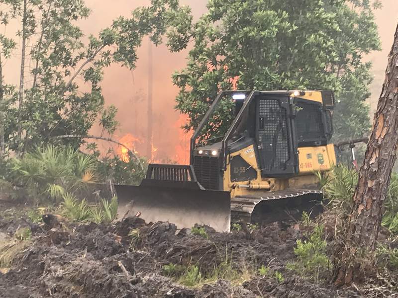 Firefighters work to contain estimated 2,200acre brush fire in Volusia