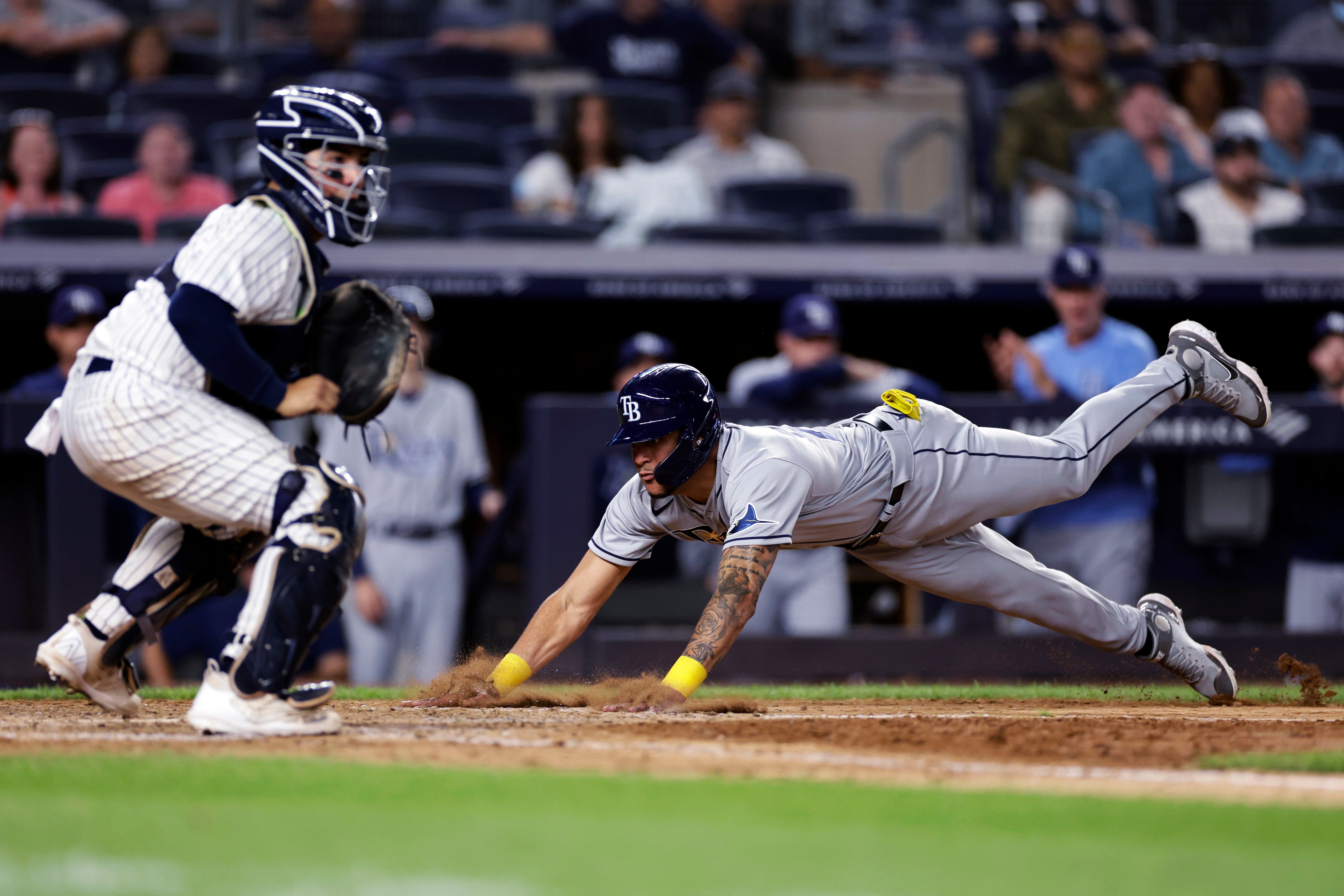 Yankees' Miguel Andujar practices fielding baseballs off the Green