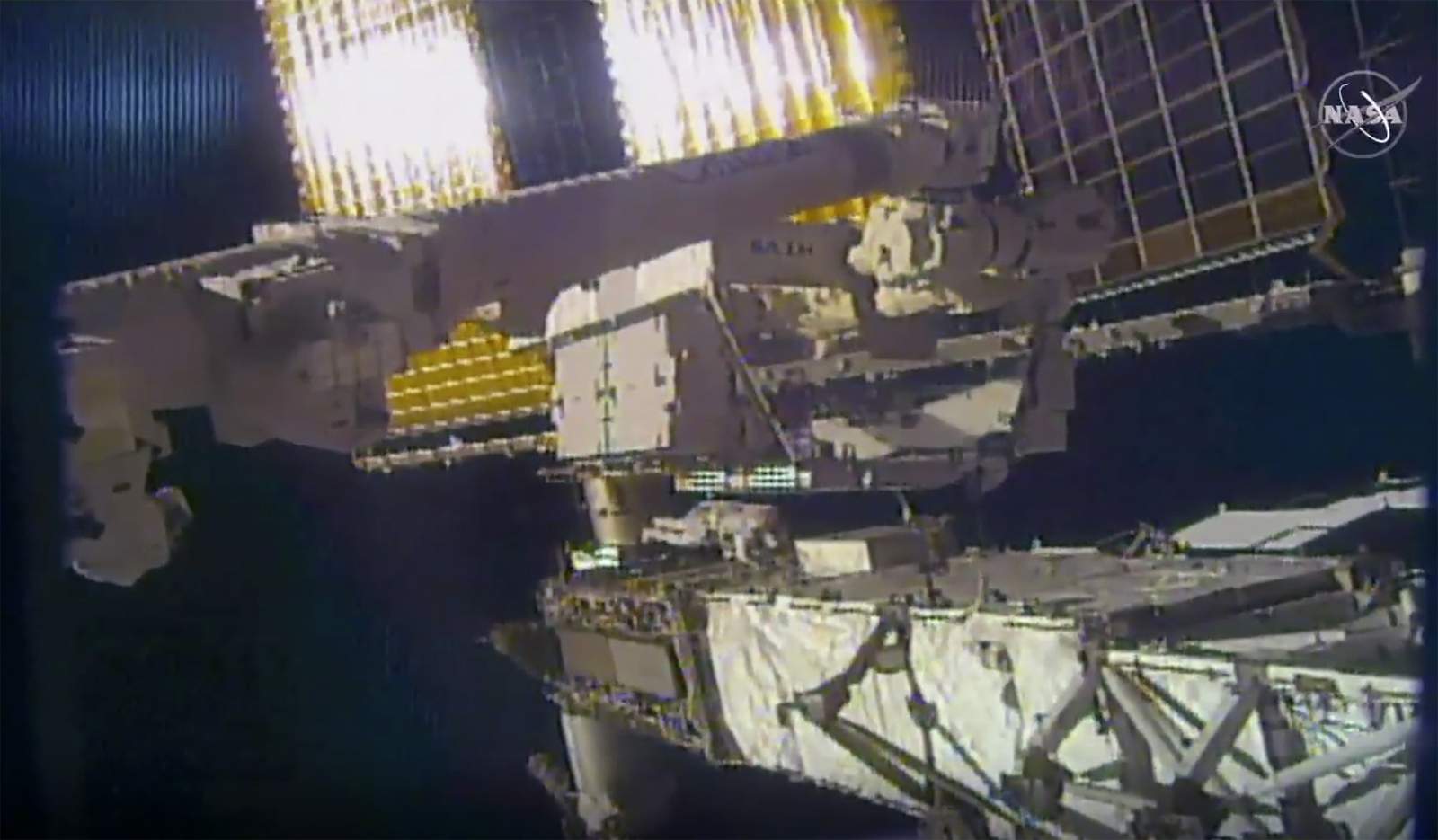 Spacewalking NASA astronauts make repairs outside space station