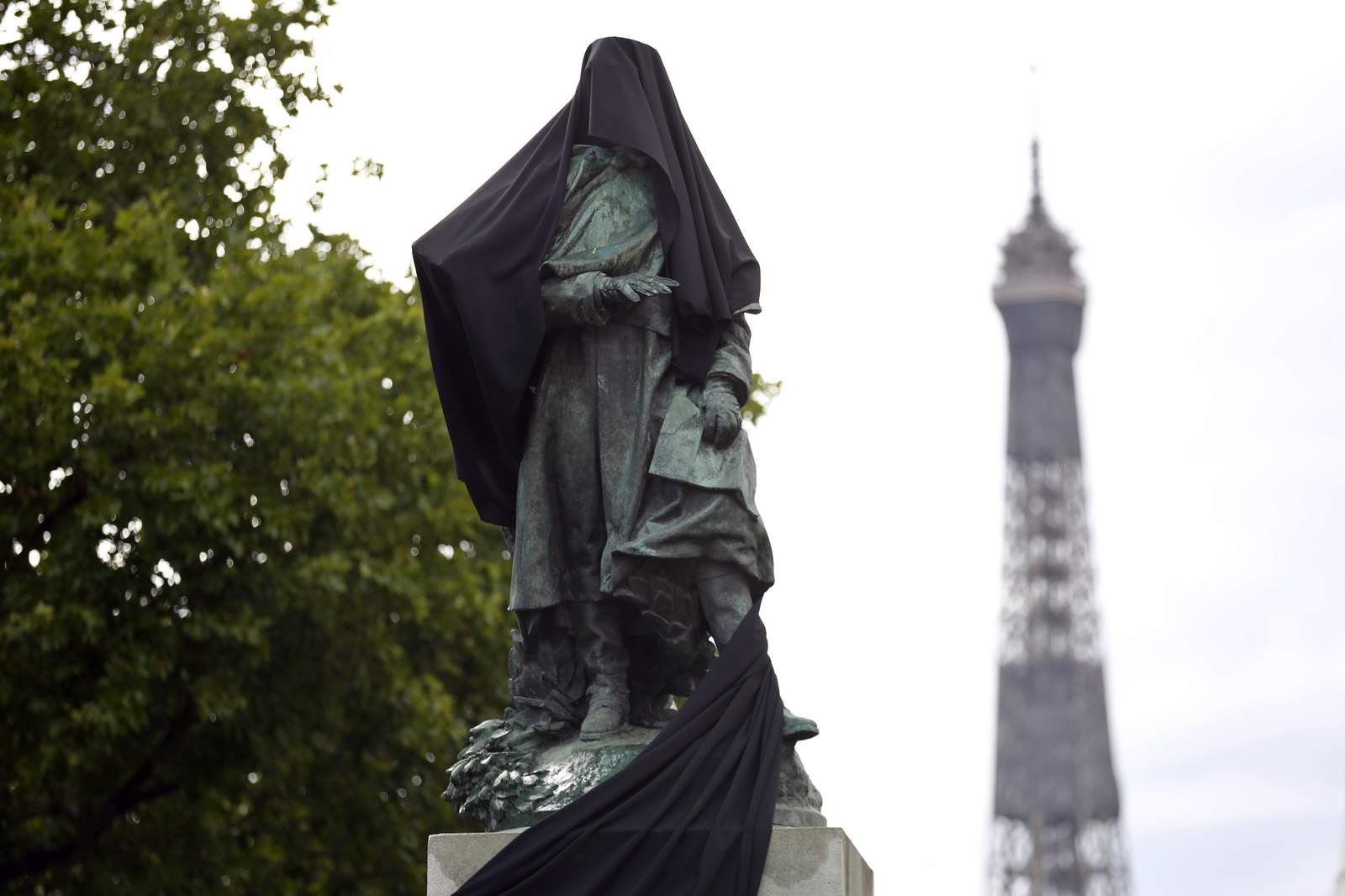 Paris protesters cloak colonial-era statue with black cloth