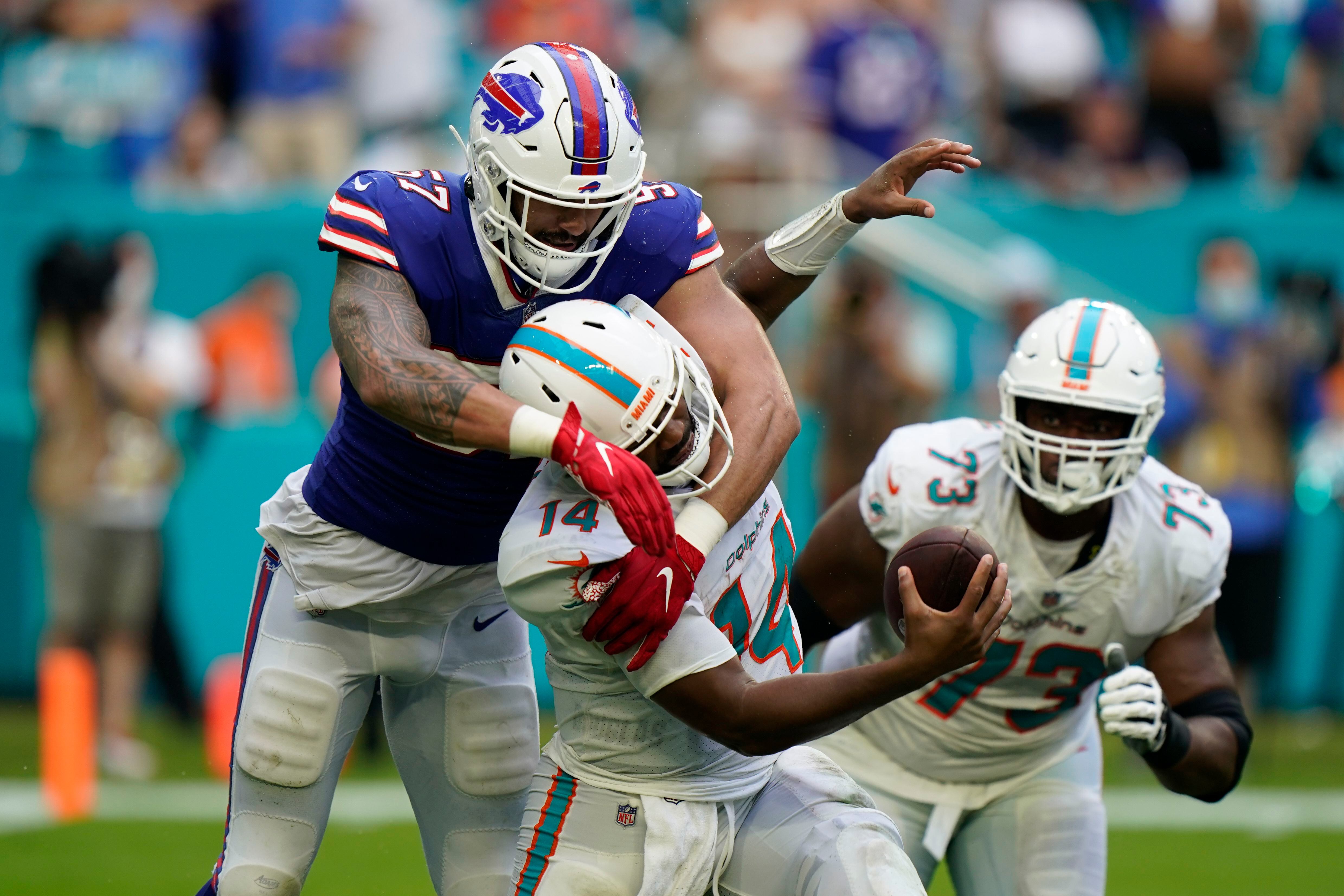 Miami Dolphins quarterback Jacoby Brissett (14) walks the