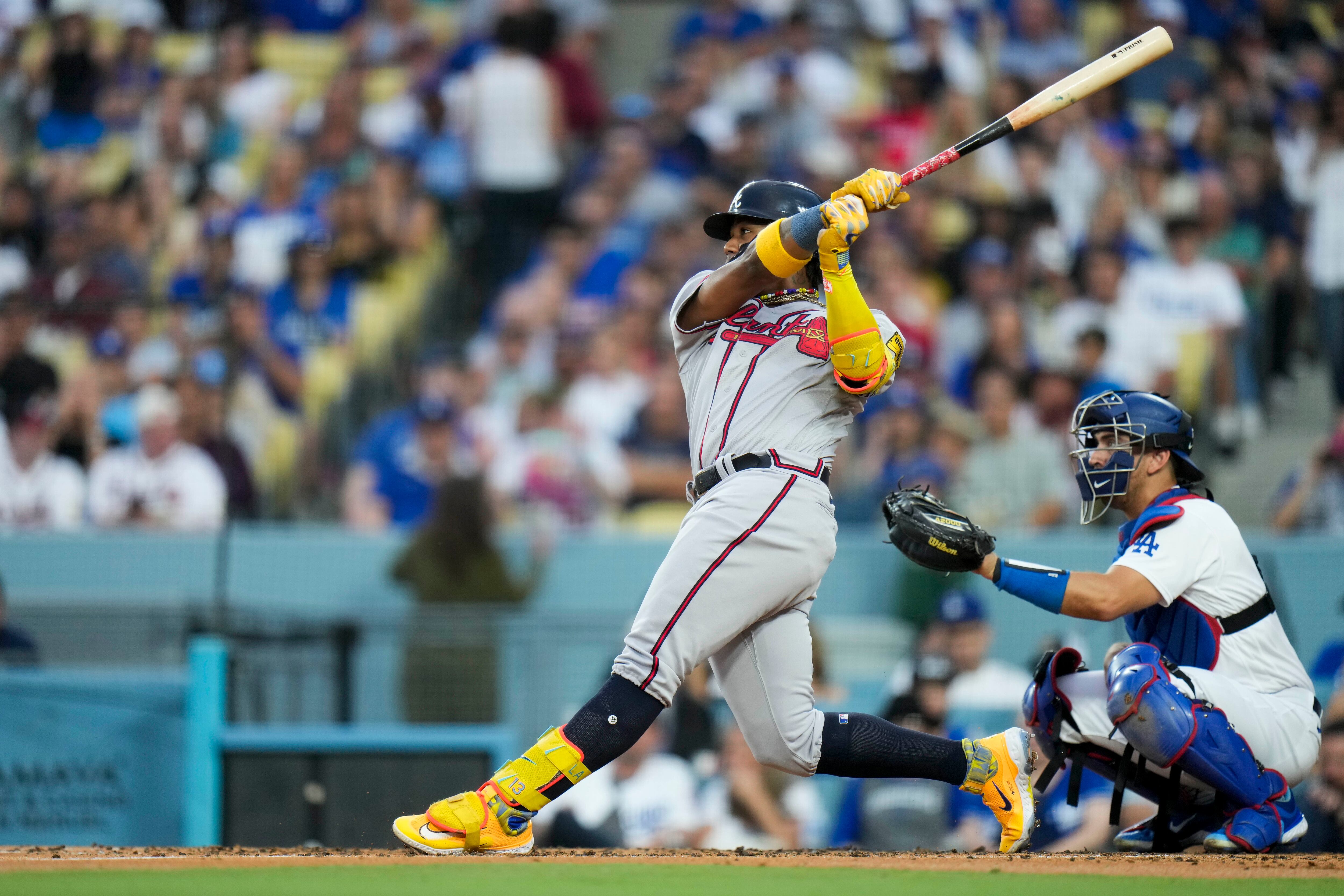 Braves' Orlando Arcia exits after being hit on the wrist with fastball