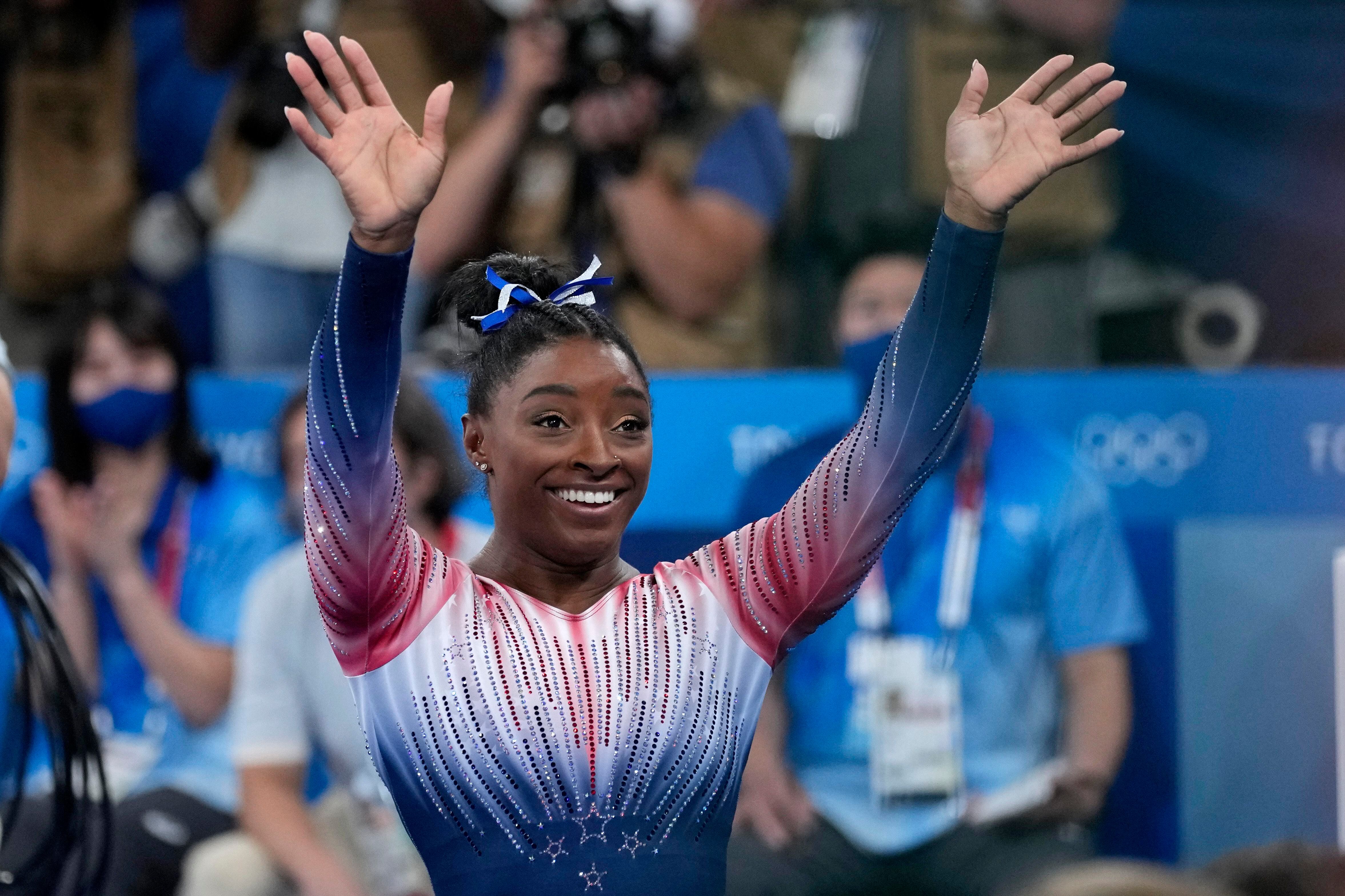 Biles returns to competition with a bronze medal and a smile