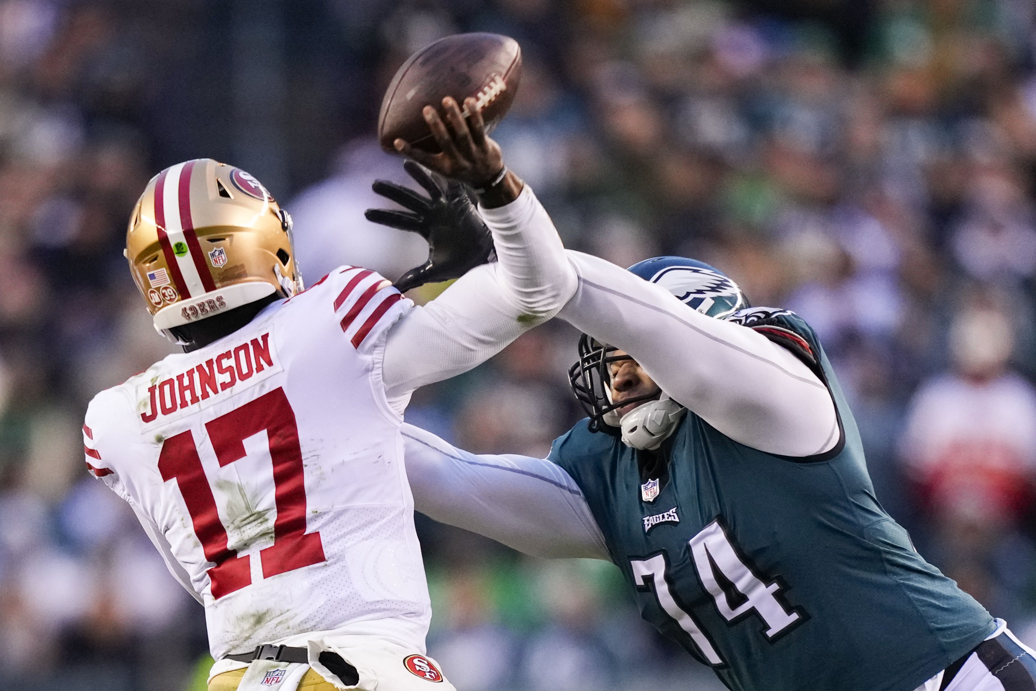 Jalen Hurts of the Philadelphia Eagles holds the George Halas