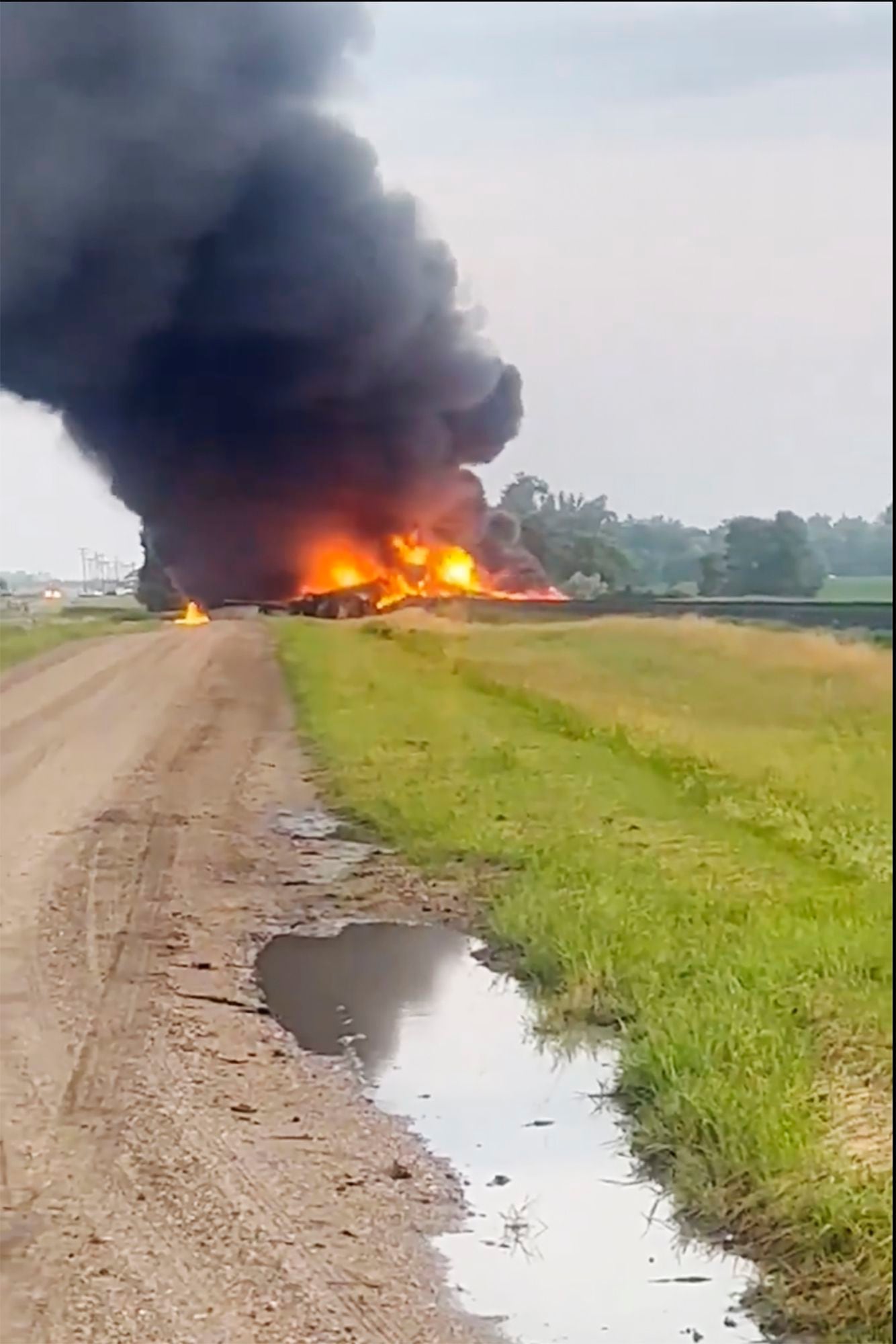 Fiery railcars with hazardous material mostly contained after derailment in North Dakota thumbnail
