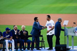 In this March 31, 2011, photo, former Los Angeles Dodgers manager Tommy  Lasorda, right, stands with former pitcher Fernando Valenzuela before a  baseball game at Dodger Stadium in Los Angeles. Lasorda, the