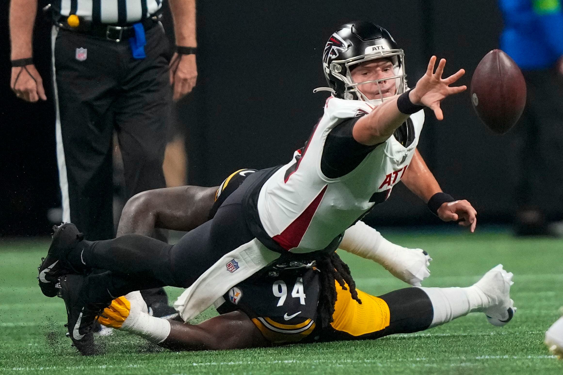 FILE - Pittsburgh Steelers linebacker T.J. Watt tackles Atlanta Falcons  quarterback Taylor Heinicke during the first half of a preseason NFL  football game Thursday, Aug. 24, 2023, in Atlanta. Watt has established